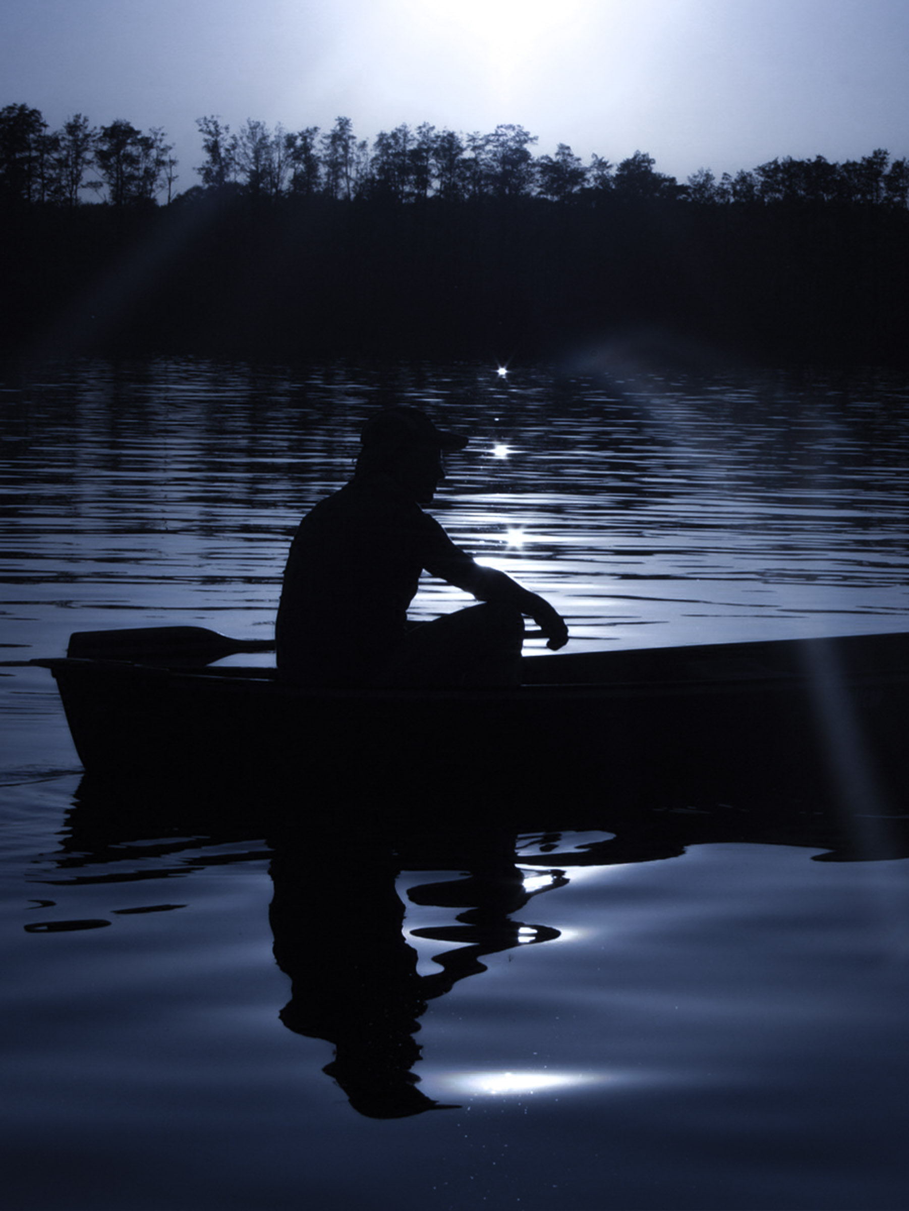 ouple enjoying a serene boat ride under the moonlit sea in Jaffna, surrounded by the calm waters and starlit sky, creating a perfect romantic ambiance.
