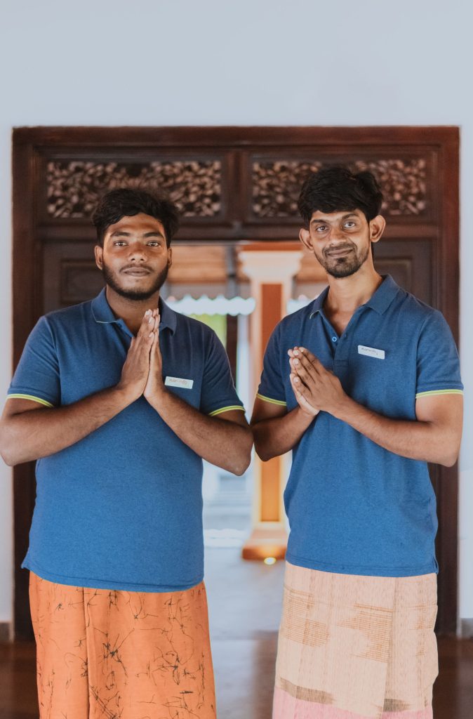 The Flamingo Villa team warmly welcoming guests at the entrance, showcasing their hospitality and friendly service in Jaffna, Sri Lanka.