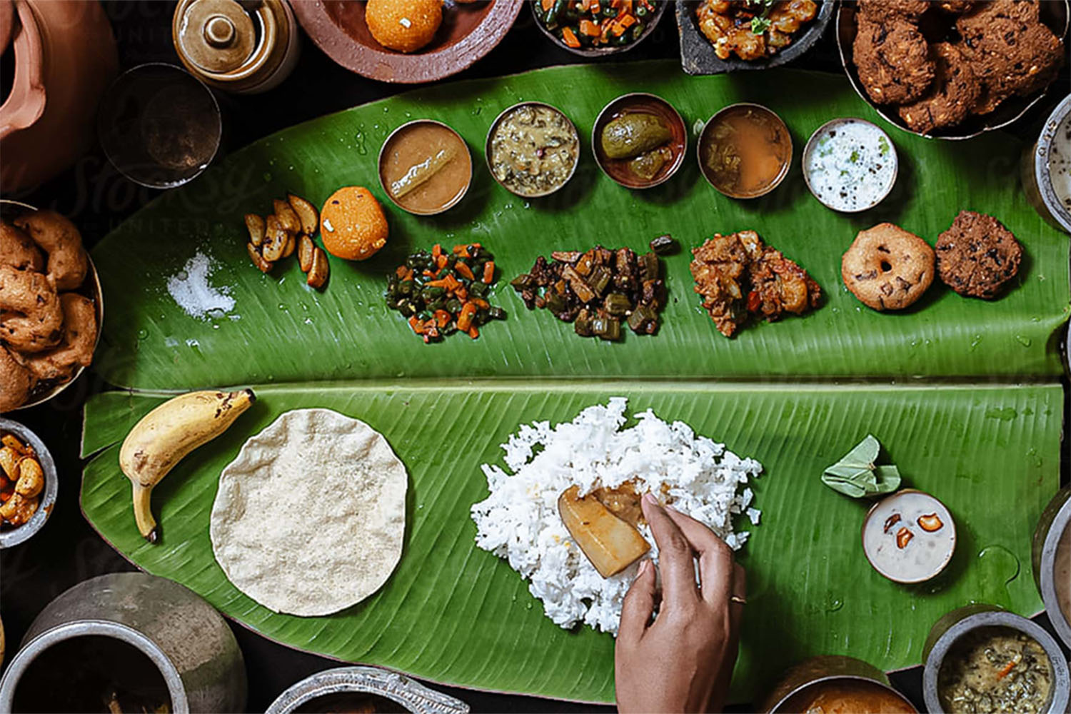 A colorful variety of Jaffna meals laid out on banana leaves, showcasing a range of traditional dishes such as rice, curries, and accompaniments, highlighting the rich culinary diversity of Jaffna cuisine.