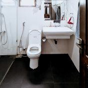The contemporary bathroom in the Chrysanthemum Room at Flamingo Villa in Jaffna, featuring a spacious shower, a bidet, and elegant fixtures for a luxurious experience.
