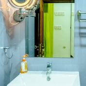 The sleek and modern bathroom in the Lemon Grass Room at Flamingo Villa, Jaffna, featuring elegant fixtures, a spacious shower, and stylish decor.