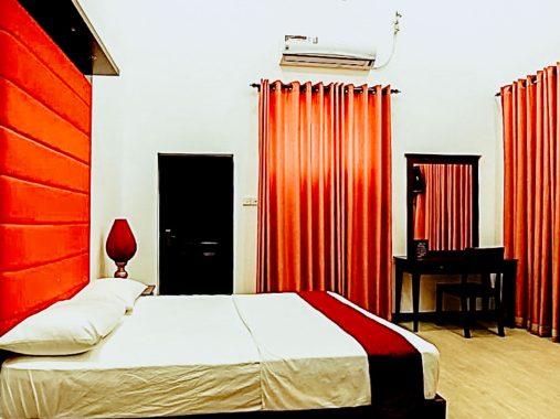The spacious Chrysanthemum Room at Flamingo Villa in Jaffna, featuring air conditioning, a wardrobe, a private bathroom with a shower and bidet, tiled flooring, and a flat-screen TV with cable channels. The room offers a comfortable double bed for a relaxing stay.